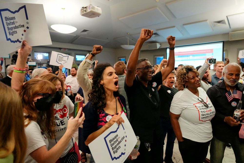 People celebrate the defeat of Issue 1, a Republican-backed measure that would have made it harder to amend the state constitution, an initiative aimed at helping defeat a November referendum that would protect abortion access in the state, after early results were announced during an election night party at the Columbus Fire Fighters Local 67 in Columbus, Ohio, U.S. August 8. (OSV News/USA Today Network via Reuters/Adam Cairns)