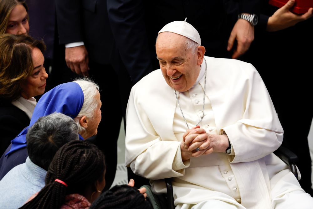 Pope Francis shares a smile with Sr. Genevieve Jeanningros of the Little Sisters of Jesus at the end of his weekly general audience in the Paul VI Audience Hall at the Vatican Dec. 20. (CNS/Lola Gomez)