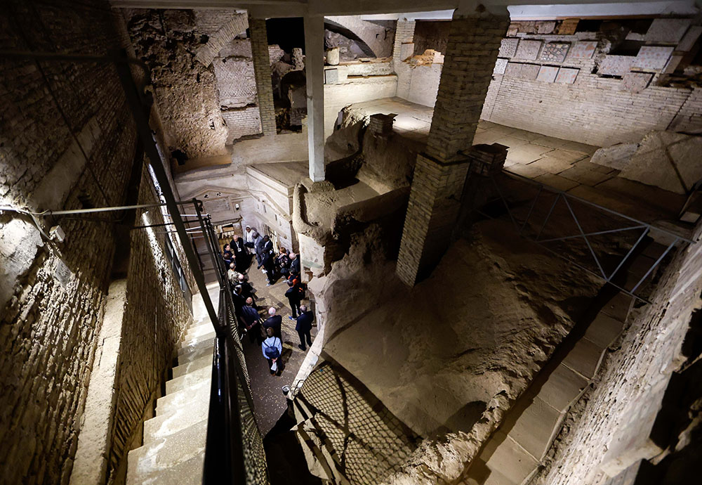 Participants in the assembly of the Synod of Bishops walk through the ancient Catacombs of St. Sebastian in Rome after praying at the Basilica of St. Sebastian as part of a pilgrimage Oct. 12. (CNS/Lola Gomez)