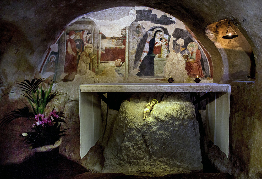 This 2013 file photo shows the fresco of St. Francis of Assisi adoring the baby Jesus in the Chapel of the Nativity in Greccio, Italy. The chapel is built in the grotto that tradition says is where St. Francis arranged the first Nativity scene in 1223. (CNS/Octavio Duran)