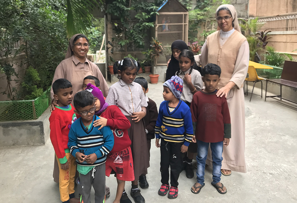 Franciscan Sisters Servants of the Cross Sr. Mary Teresita (left) and Sr. Mary Clare (right), founders of Jyothi Seva, are pictured with students in Bengaluru, southern India. (Thomas Scaria)