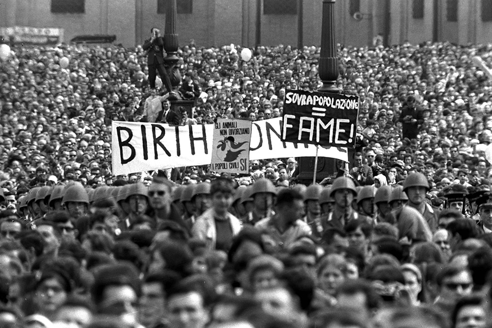 Posters are hoisted in St. Peter's Square by a group of persons favoring artificial birth control, as Pope Paul VI appears at the central balcony of St. Peter's Basilica to read his Easter message to the world and impart his "urbi et orbi" blessing March 26, 1967. (AP)