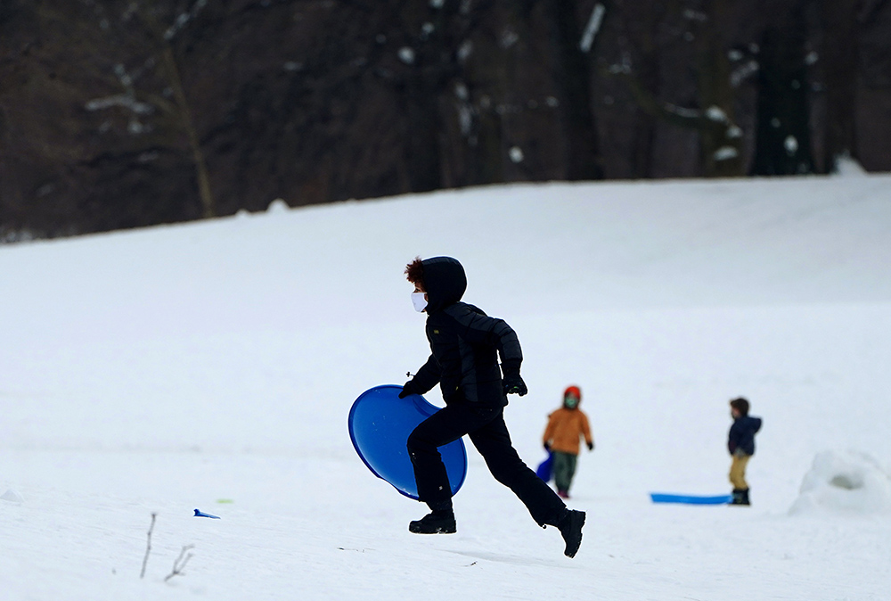 Children in the Brooklyn borough of New York City play in the snow Feb. 10, 2021. (CNS/Reuters/Carlo Allegri)