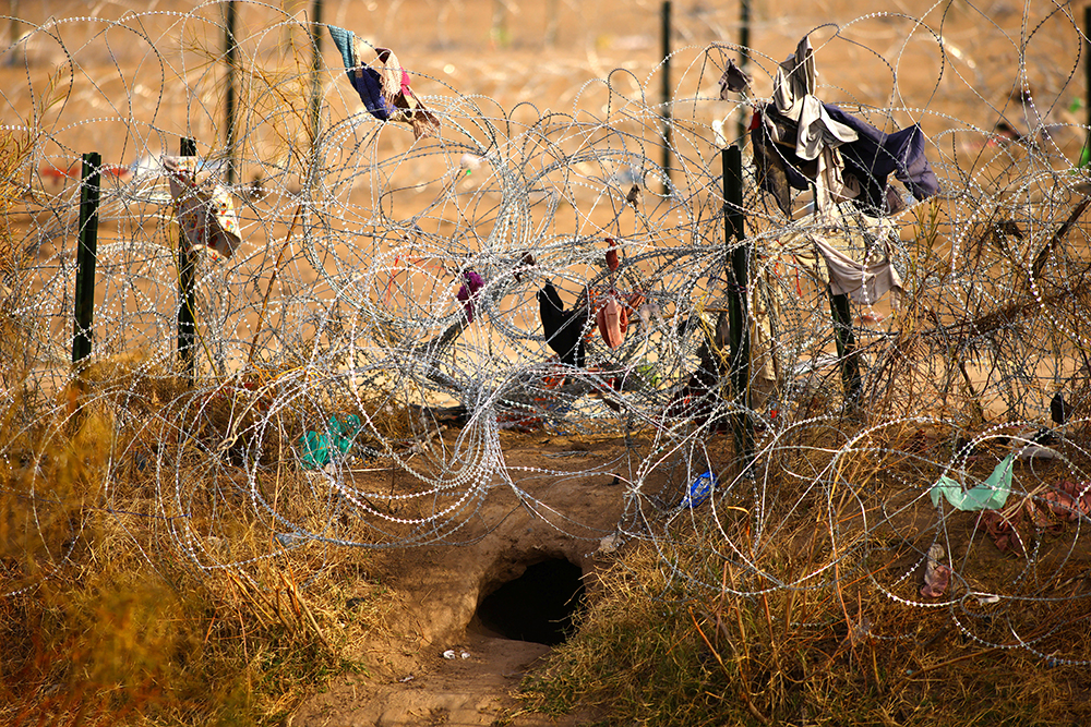 A hole is seen from Ciudad Juarez, Mexico, Feb. 1, 2024, near a razor wire fence the state of Texas is using to prevent migrants from crossing into the U.S. at the border. U.S. senators Feb. 4 unveiled a deal on border enforcement paired with security assistance for Ukraine, Israel and Indo-Pacific countries. (OSV News/Reuters/Jose Luis Gonzalez)