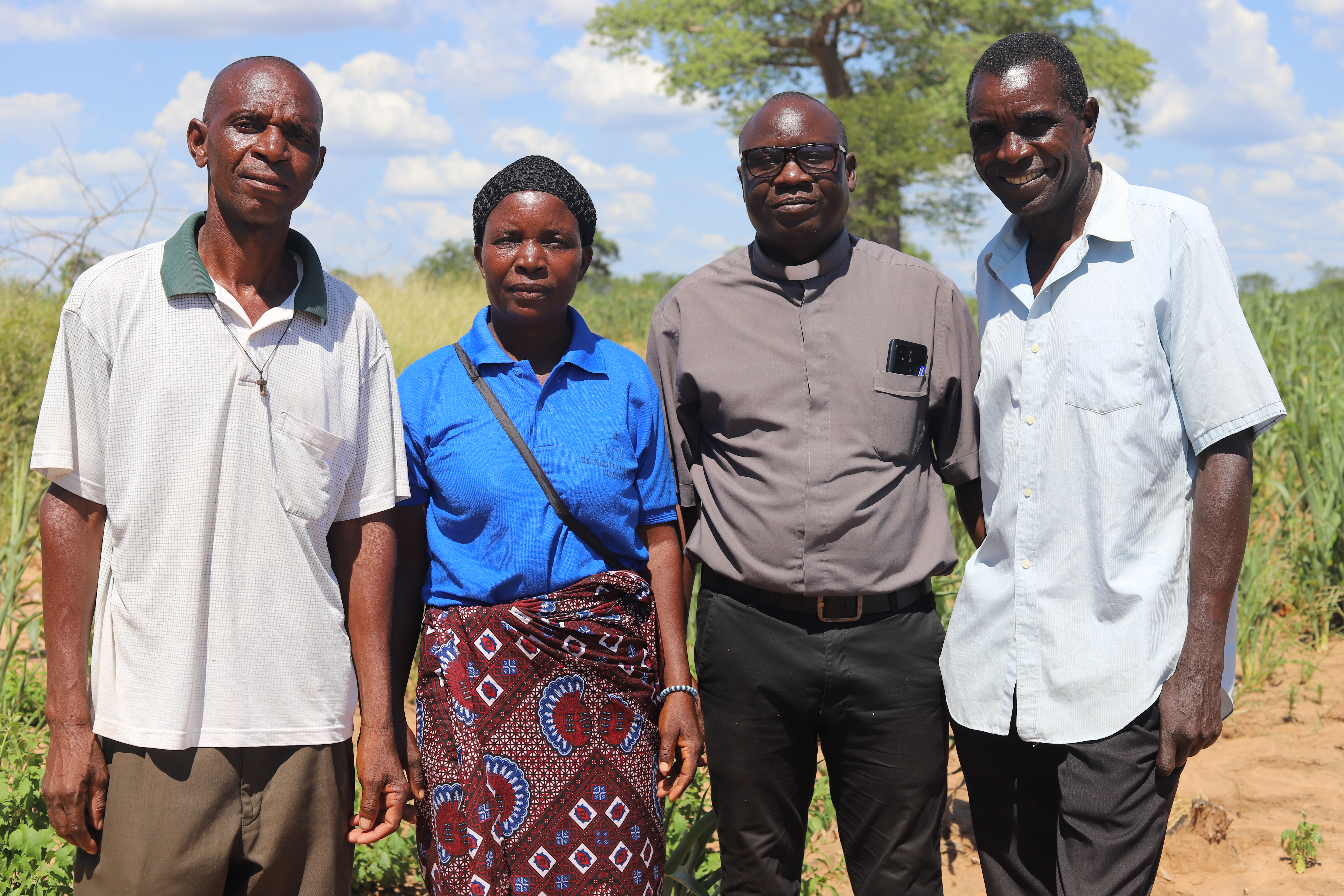 Fr. Christopher Dabu is pictured with farmers.