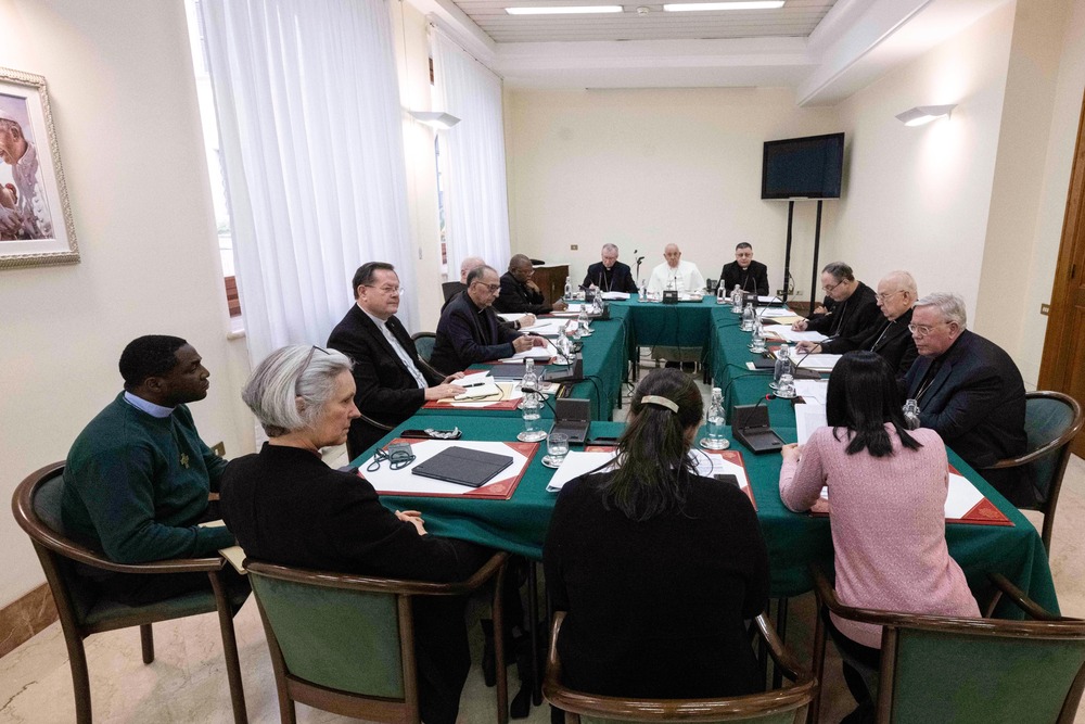 Assembly of people gathered around conference table