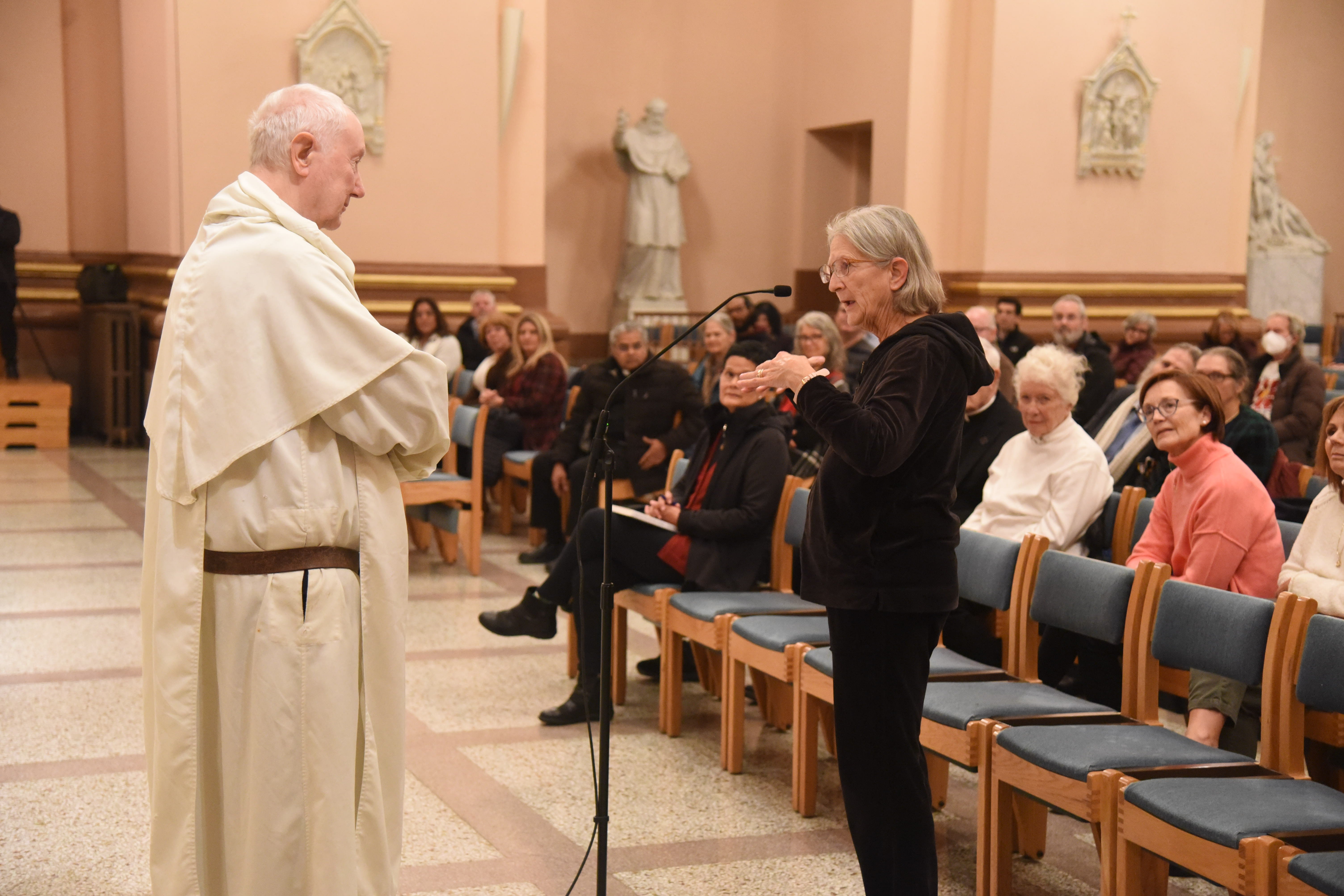 Lucy Robie, a member of St. Thomas the Apostle Parish in Fortville, Indiana, asks a question of Dominican Fr. Timothy Radcliffe