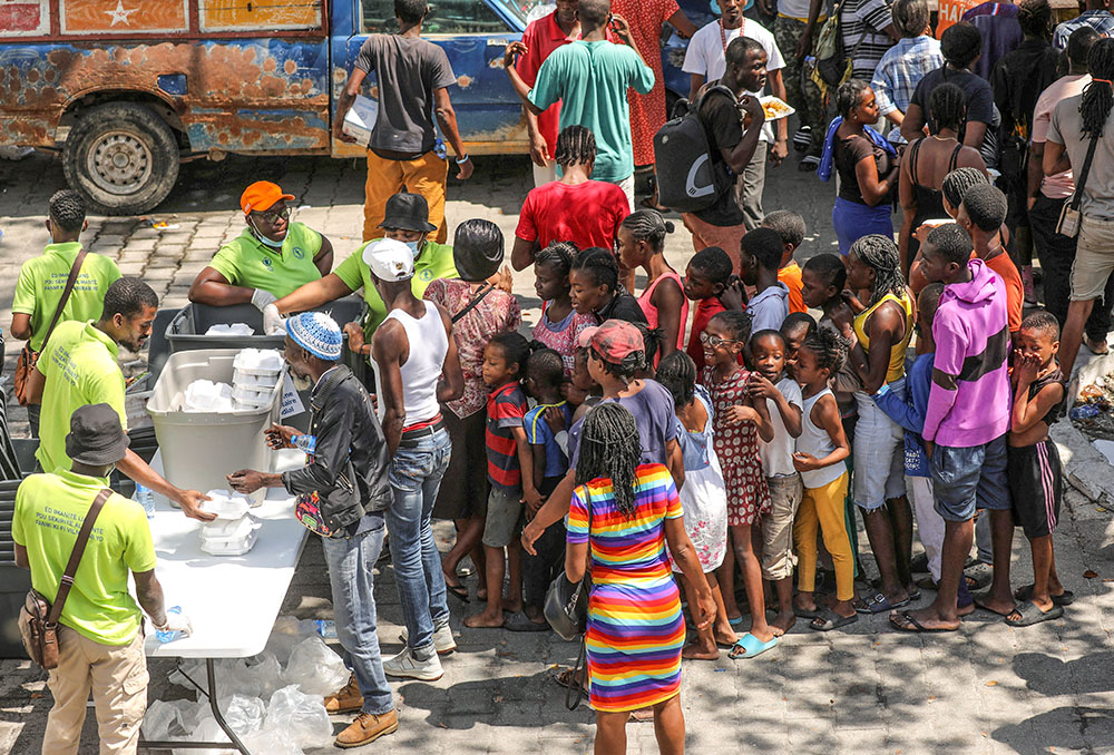 Residents who fled violence gather to receive meals at a school being used for shelter in Port-au-Prince, Haiti, March 4. (OSV News/Reuters/Ralph Tedy Erol)