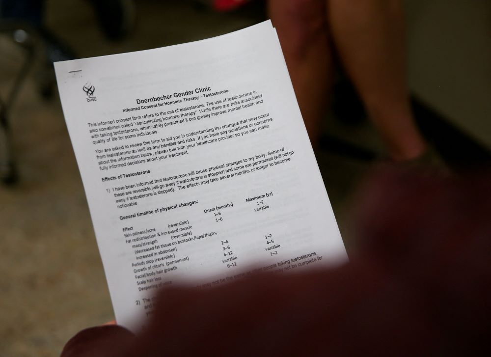 A person holds a consent form for testosterone therapy during an appointment at Oregon Health & Science University's Doernbecher Gender Clinic in Portland, Oregon, May 10, 2022. (OSV News/Reuters/Lindsey Wasson)