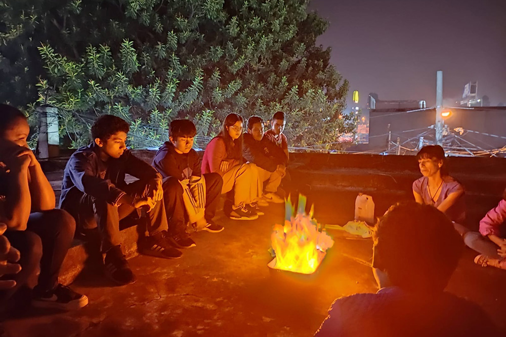 Nancy Mancera spends time with a group of teenagers on the rooftop of the sisters' house during their farewell on April 06 in Guatemala City, Guatemala. Reflecting on the Resurrection story in John 21, the sisters assured the teens that although they are leaving the city, Jesus will always be with them. (Rosa Nima)