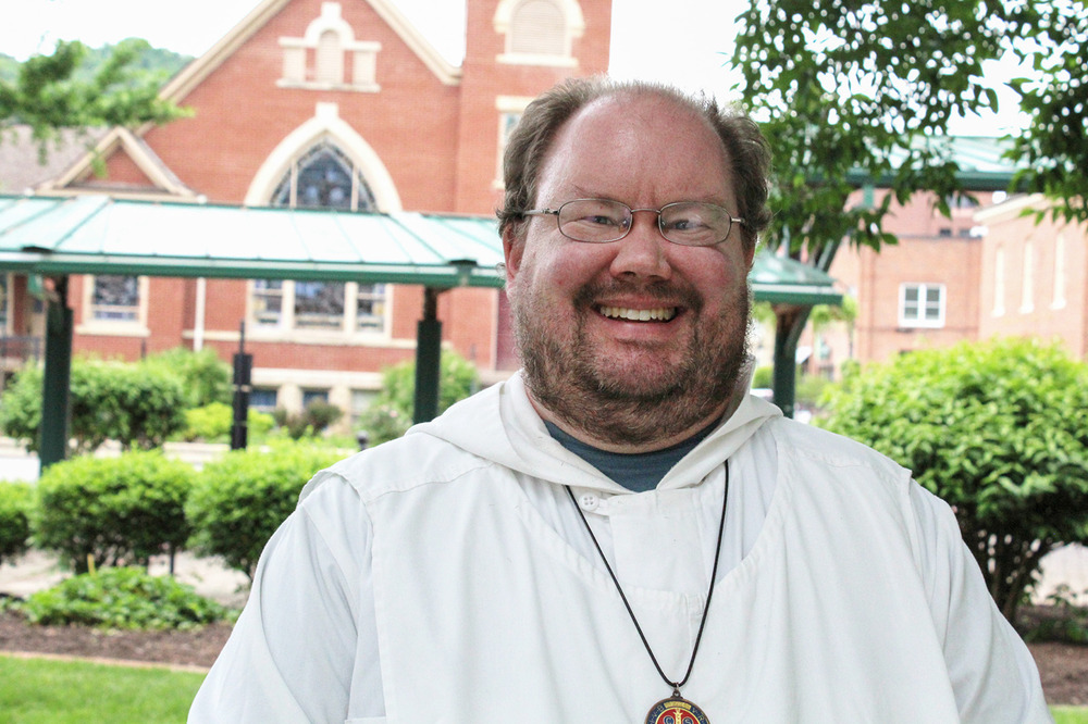 Brother Matson pictured smiling in front of a church building. 