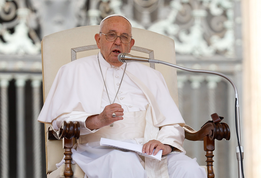 Pope Francis speaks to visitors in St. Peter's Square during his general audience May 29 at the Vatican. (CNS/Lola Gomez)