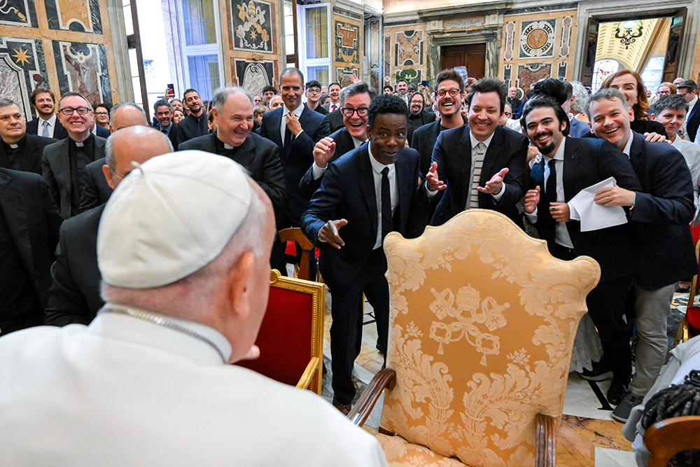 Pope Francis engages in a light-hearted moment with comedians Stephen Colbert, Chris Rock, Jimmy Fallon and other comedians after an audience at the Vatican June 14, 2024. (CNS/Vatican Media)