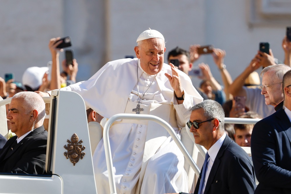 Pope Francis raises hand in greeting from popemobile