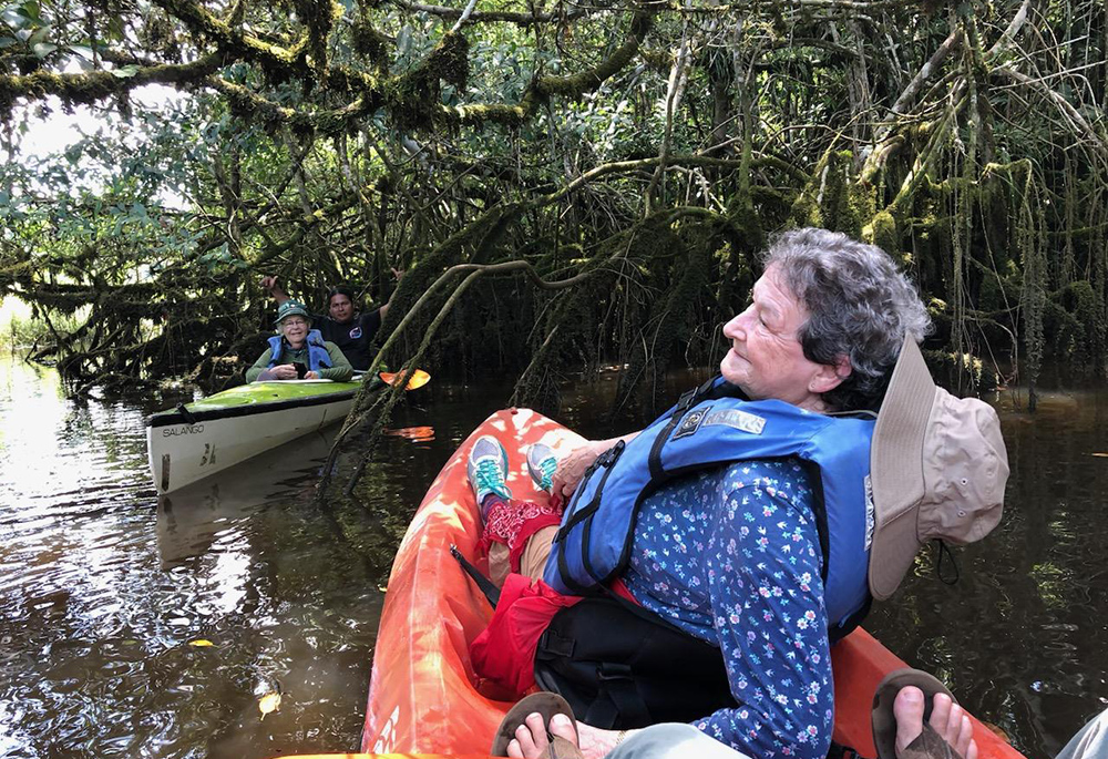 Adrian Dominicans Sr. Lorene Heck (foreground) and Sr. Mary Priniski with Achuar guide Celestino Antik, travel on the Pastaza River during an ecotourism trip through Maketai, a nonprofit co-founded by Adrian Dominican Sr. Judy Bisignano. The ecotrips give Western visitors a close-up introduction to both the Achuar and the Amazon. (Courtesy of Lorene Heck)