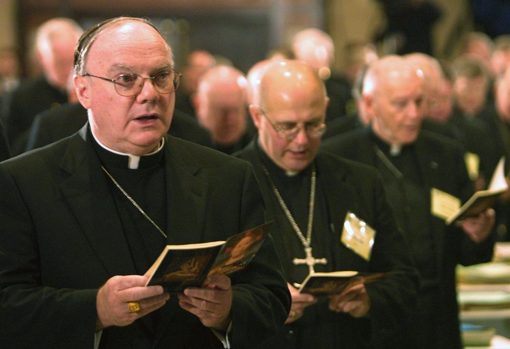 Bishop George Coleman of Fall River, Massachusetts, joins fellow bishops during the opening prayer of the U.S. Conference of Catholic Bishops' general meeting Nov. 10, 2003, in Washington. (CNS/Bob Roller)