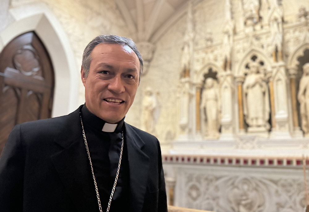 Auxiliary Bishop Lizardo Estrada Herrera of Cuzco, Peru, stops by the altar of St. Rose of Lima at St. Patrick's Cathedral, July 8 in New York City. Estrada, general secretary of the Latin American bishops' council, said you can't kneel with reverence before the Eucharist while also rejecting the poor, including migrants, working toward measures that lead to their death or lack of dignity. (NCR photo/Rhina Guidos)