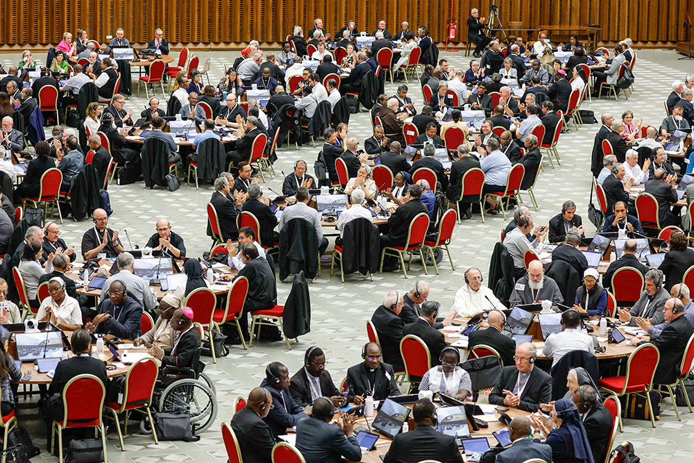 Members of the assembly of the synod on synodality start a working session in the Vatican's Paul VI Audience Hall Oct. 18, 2023. (CNS/Lola Gomez)