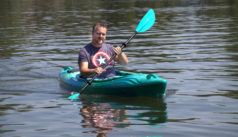 Man in kayak on water. 