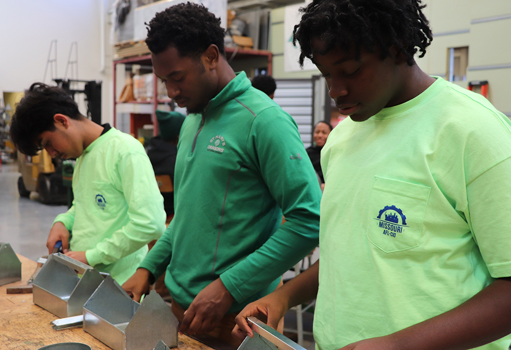 St. Mary's South Side Catholic High School students (from left to right) Omar Navarette, Roderick Brown and Samuel Wynn work with sheet metal in class during the 2023-2024 school year. (Courtesy of St. Mary's South Side Catholic High School)