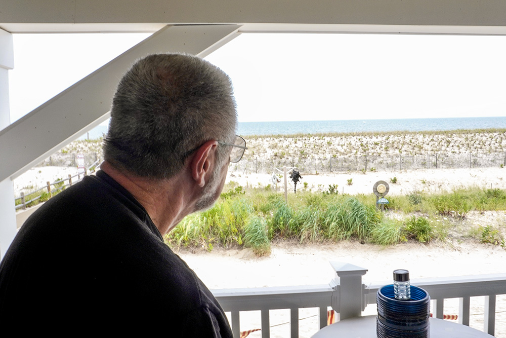 Fr. Ed Reading looks at the view from the balcony of his home on the Jersey Shore in July. (Camillo Barone)