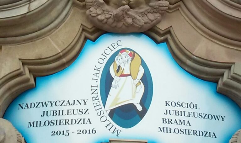 Logo with text and icon framed by stone carving. 