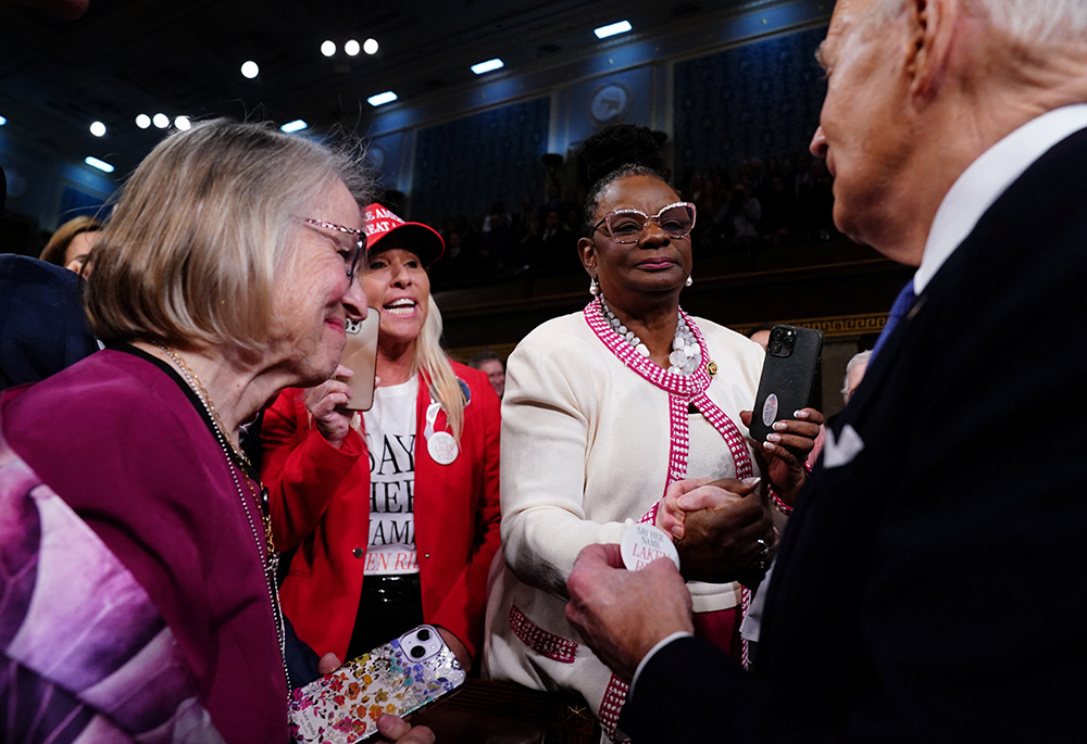 U.S. Rep. Marjorie Taylor Greene of Georgia, center, attempts to speak to President Joe Biden as he arrives to the House Chamber of the U.S. Capitol for his third State of the Union address to a joint session of Congress, March 7 in Washington. (OSV News/Reuters/Shawn Thew)