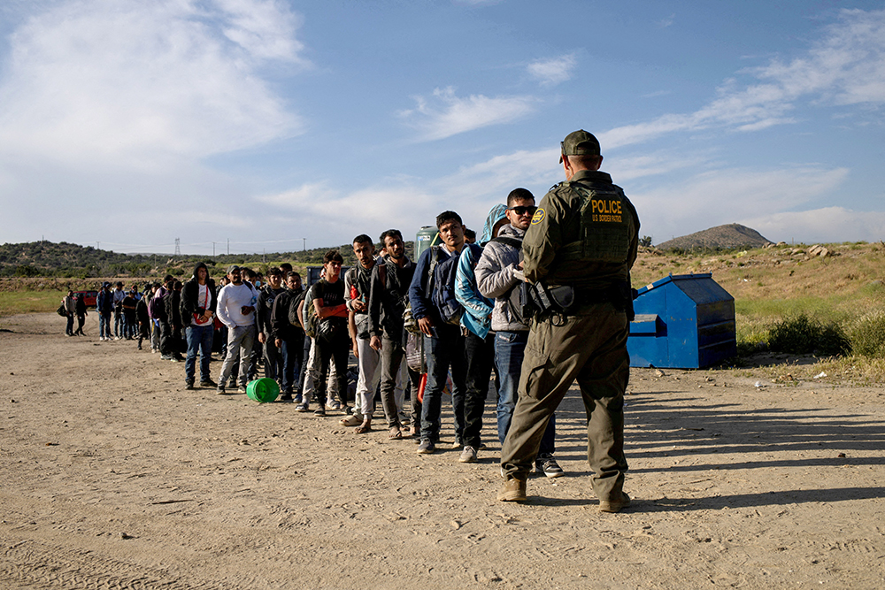 Migrants from Jordan, China, Egypt and Colombia surrender to a Border Patrol agent after crossing into the U.S. from Mexico in Jacumba Hot Springs, California, May 15, 2024. (OSV News/Reuters/Adrees Latif)