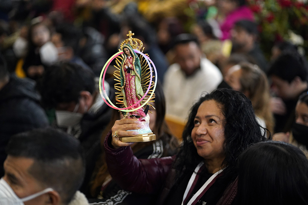 A woman holds a statue of Our Lady of Guadalupe during a Spanish-language Mass celebrated on the eve of the feast of Our Lady of Guadalupe at Our Lady of Mount Carmel Church in Staten Island, New York, Dec. 11, 2022. (OSV News/Gregory A. Shemitz)