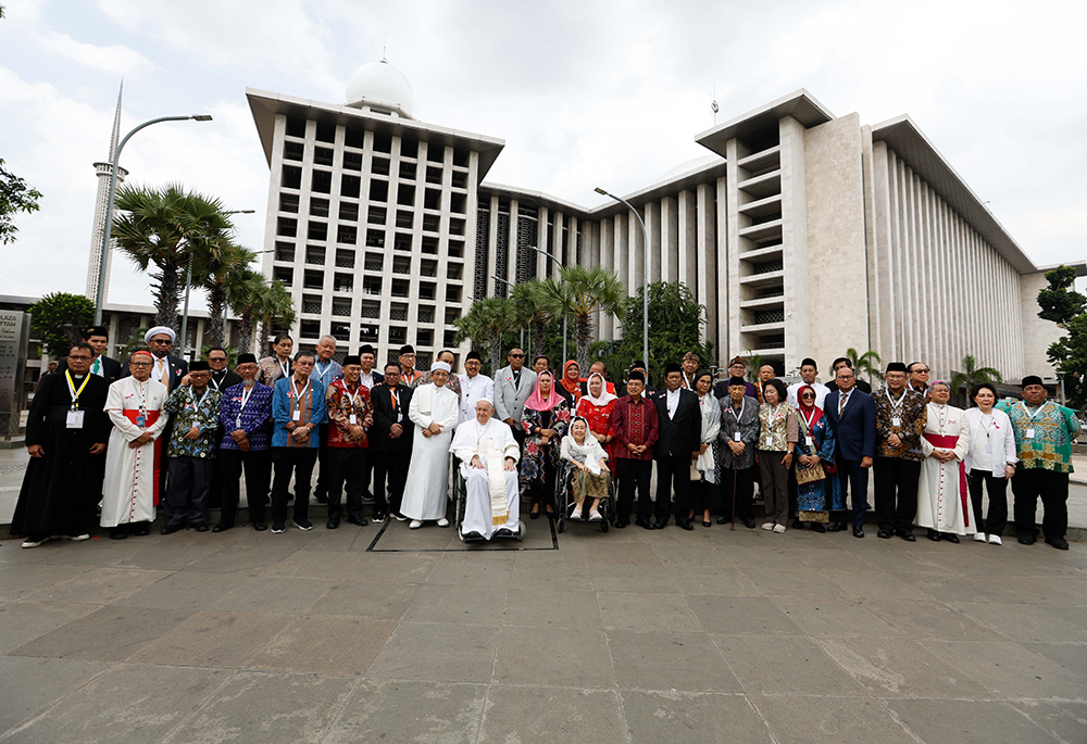 Pope Francis and Nasaruddin Umar, grand imam of the Istiqlal Mosque, pose for a photo with Muslim, Christian, Hindu, Buddhist and representatives of other religions at the conclusion of an interreligious meeting in Jakarta, Indonesia, on Sept. 5. (CNS/Lola Gomez)