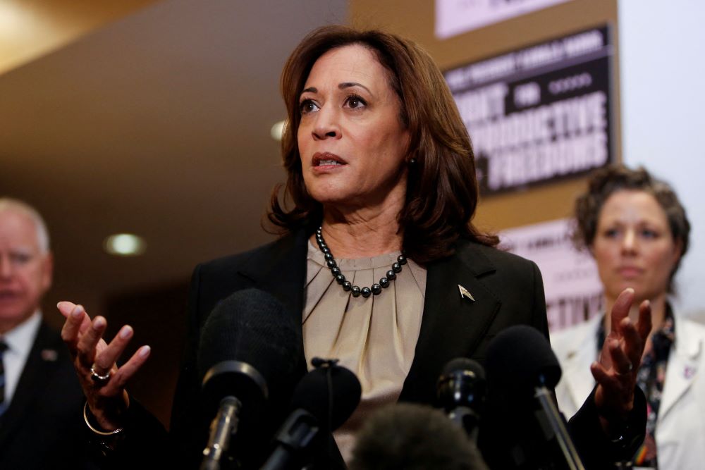 Minnesota Gov. Tim Walz and Dr. Sarah Traxler look on as U.S. Vice President Kamala Harris speaks as she visits an abortion clinic in Minneapolis March 14. 