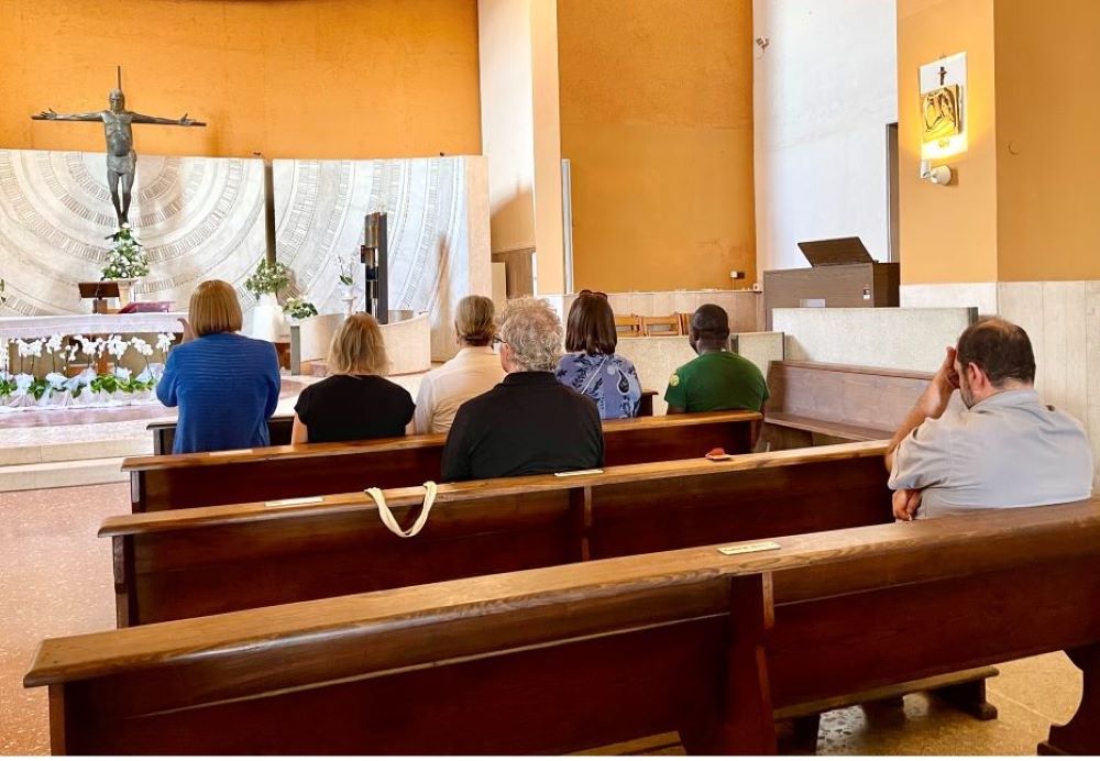 Maureen Rasmussen, Christine Zuba, Lynn Discenza and Martha Marvel pray the rosary with Fr. Andrea Conocchia in his parish in Torvaianica, a town outside Rome, on Sept. 16. (Camillo Barone)