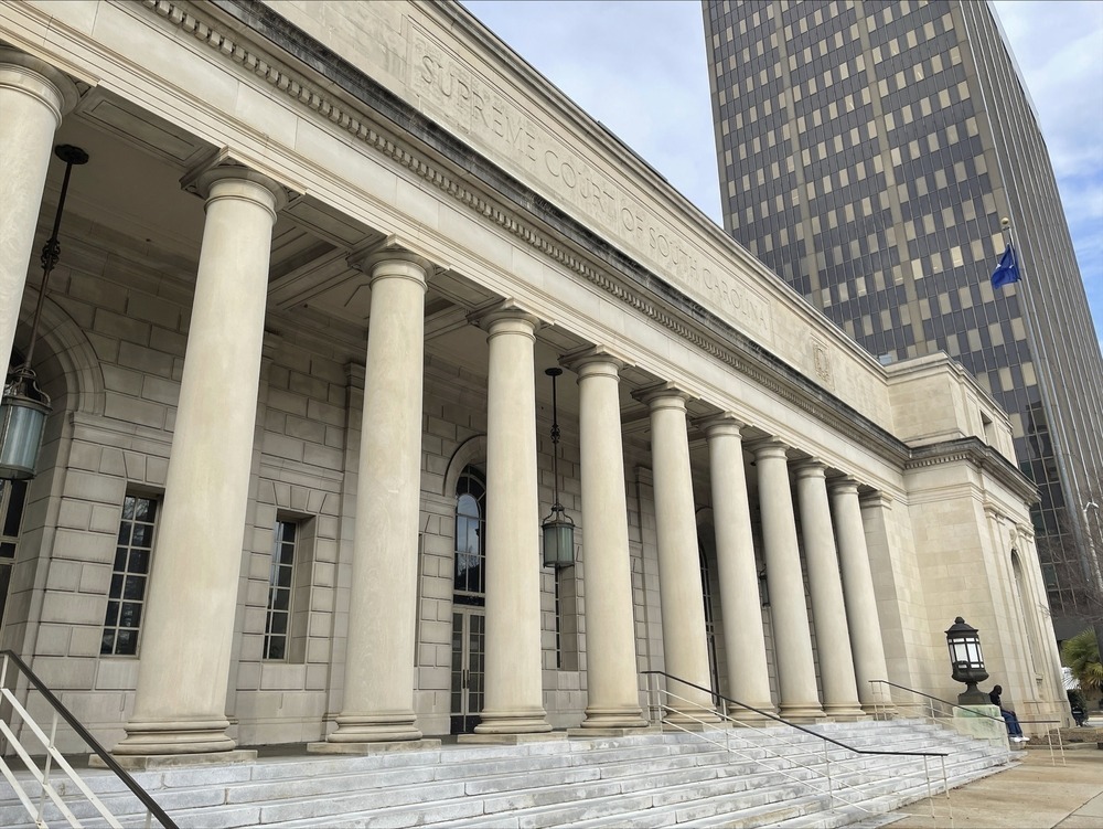 Stone facade in built-up urban core.