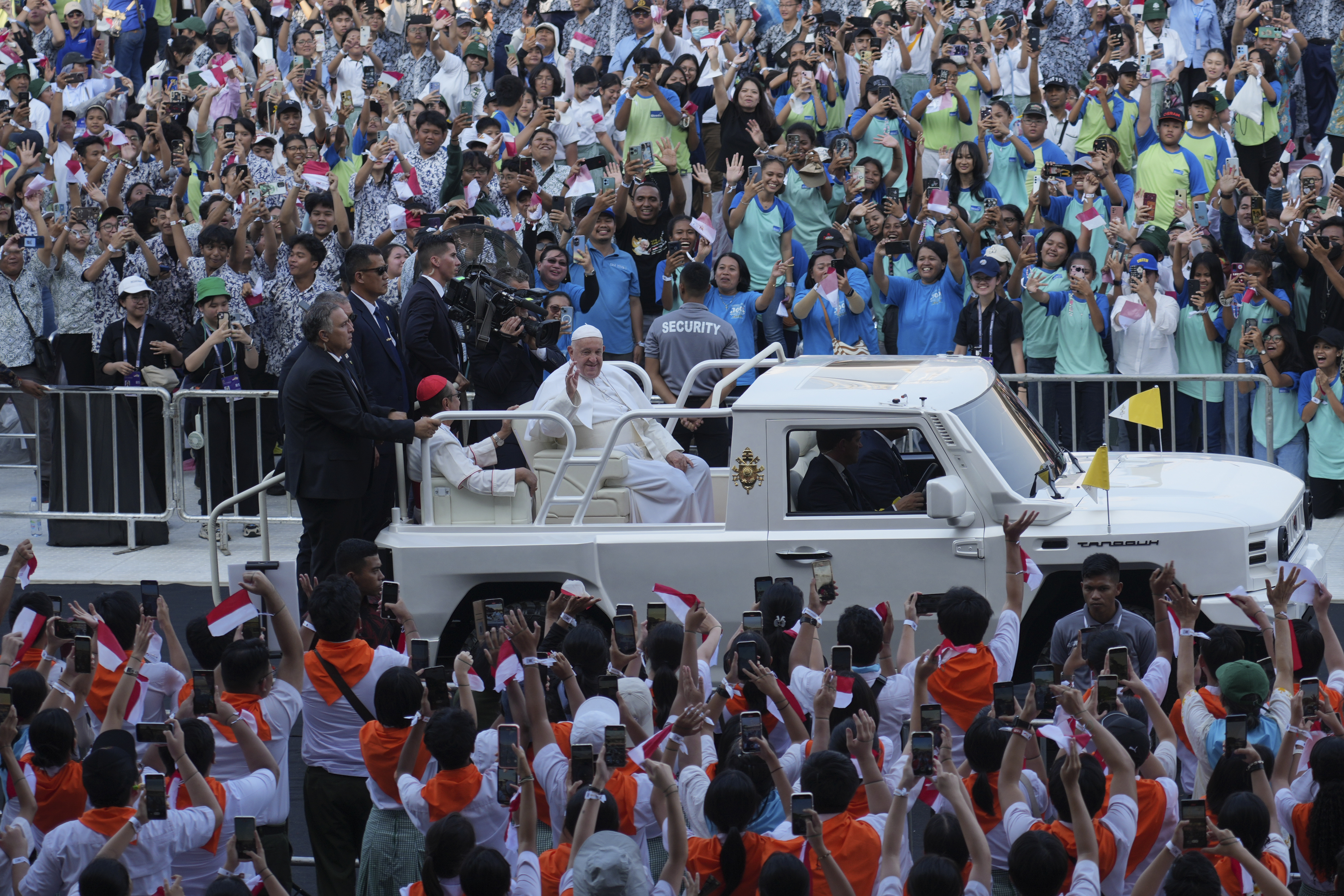 People react as Pope Francis arrives at Madya Stadium in Jakarta, Indonesia, Sept. 5. 