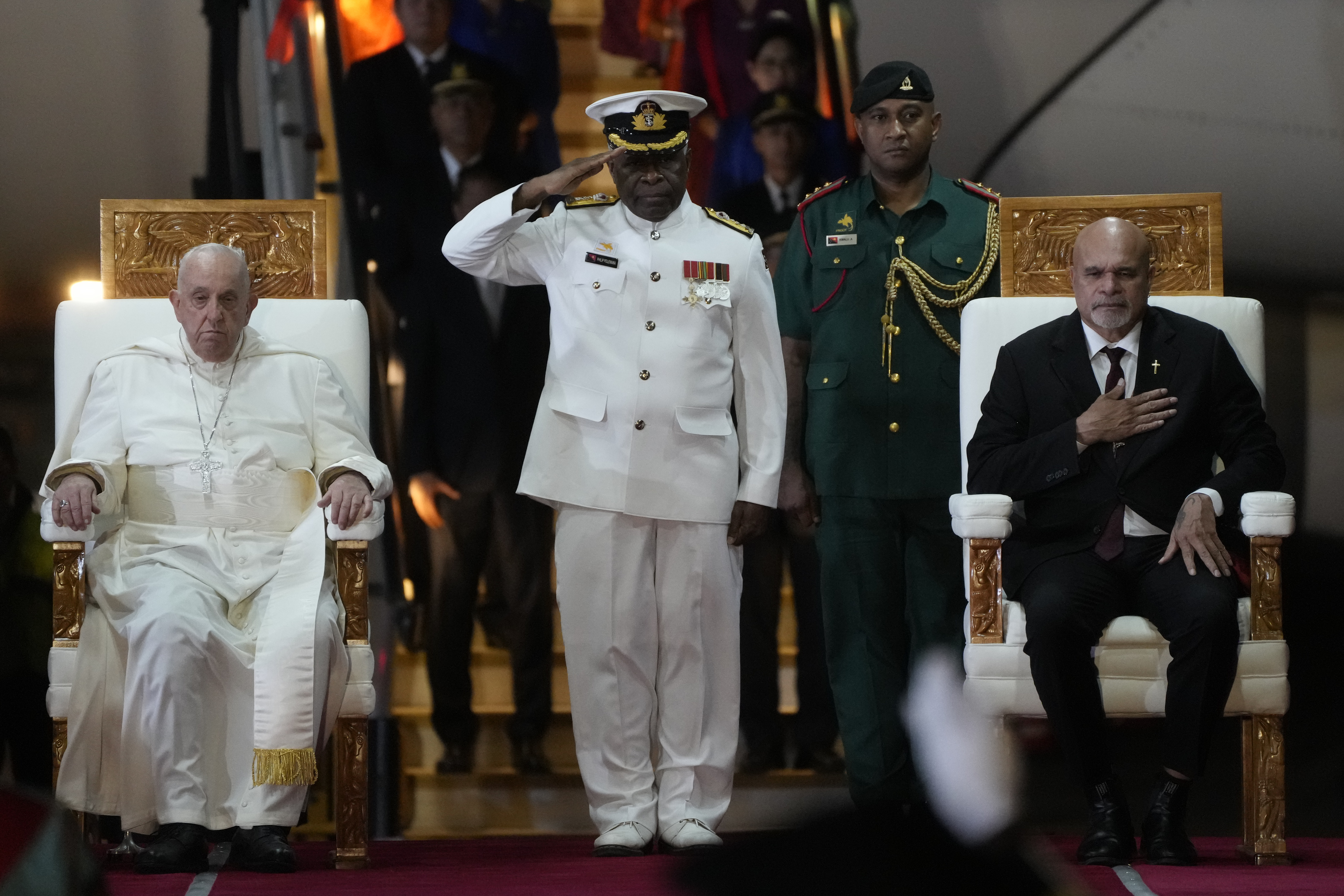 Pope Francis, left, is welcomed by Papua New Guinea's deputy Prime Minister John Rosso, right, and rear-Admiral Philip Polewara, center, as he arrives at Port Moresby's "Jackson" International Airport, Sept. 6, 2024. As a second leg of his 11-day trip to Asia and Oceania Pope Francis' visit to Papua New Guinea will take him to a remote part of the South Pacific island nation where Christianity is a recent addition to traditional spiritual beliefs developed over millennia. (AP/Gregorio Borgia)