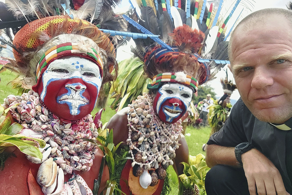 This undated photo provided by Fr. Tomas Ravaioli shows local villagers posing for a photo with him in Goroka, Papua New Guinea. (Fr. Tomas Ravaioli via AP)