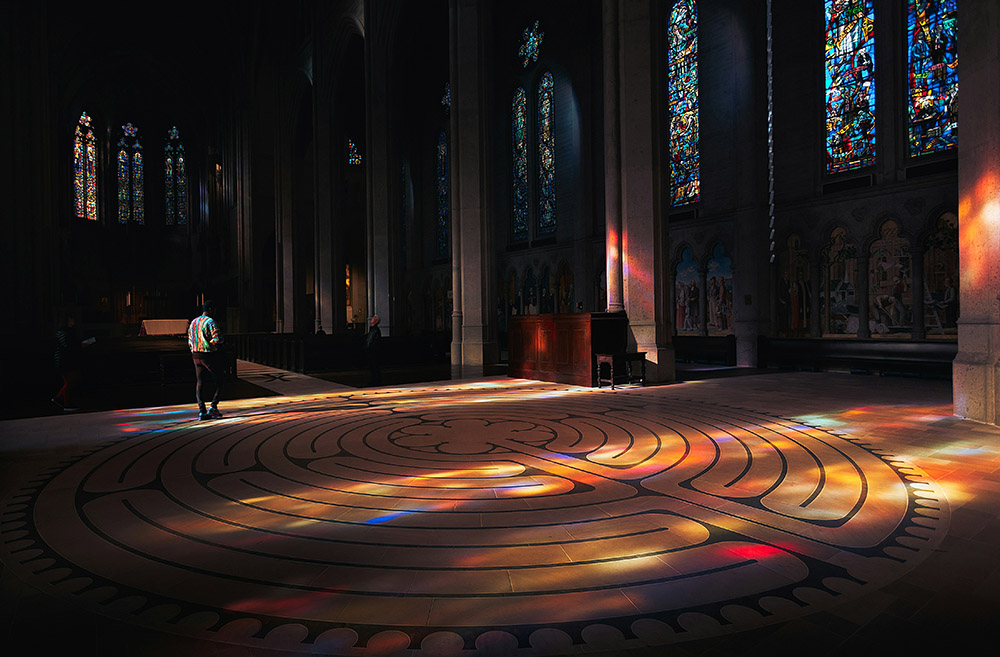 A person walks through a labyrinth in a church (Unsplash/Erez Attias)