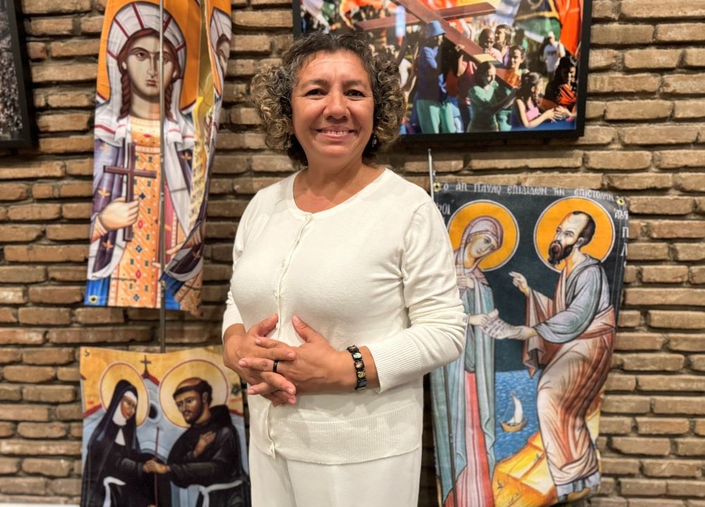 Rosa Bonilla stands near a banner representing St. Phoebe with St. Paul the Apostle at San Lorenzo chapel at the Centro Internazionale Giovanile in Rome Oct. 3.