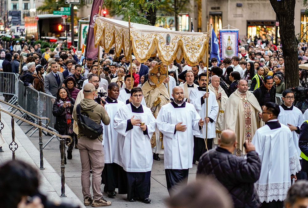 Archbishop Paul Coakley of Oklahoma City, ecclesiastical adviser to the Napa Institute, carries the monstrance during a eucharistic procession through Midtown Manhattan in New York City Oct. 15. A few thousand worshippers packed St. Patrick's Cathedral for Holy Hour and Mass before participating in the procession. (OSV News/Gregory A. Shemitz)