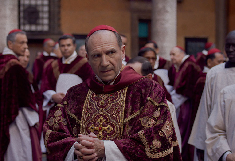 In the new film "Conclave," fictional cardinals (led by Ralph Fiennes, pictured) are tasked with selecting a new pope when the acting Holy Father suddenly dies. (Focus Features)