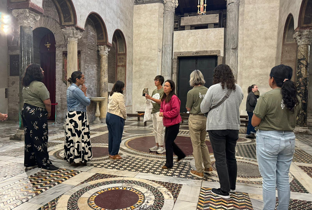 Members of a pilgrim group learning about the diaconate and speaking in Rome on women's service to the church line up for Communion Oct. 5, 2024, at the Basilica of Santa Maria Cosmedin in Rome. The group, advocating for the women's diaconate, include women who work with migrants in the U.S., with Aboriginal people in Australia and with those being persecuted and killed in places like Brazil for their defense of the environment. (NCR photo/Rhina Guidos)