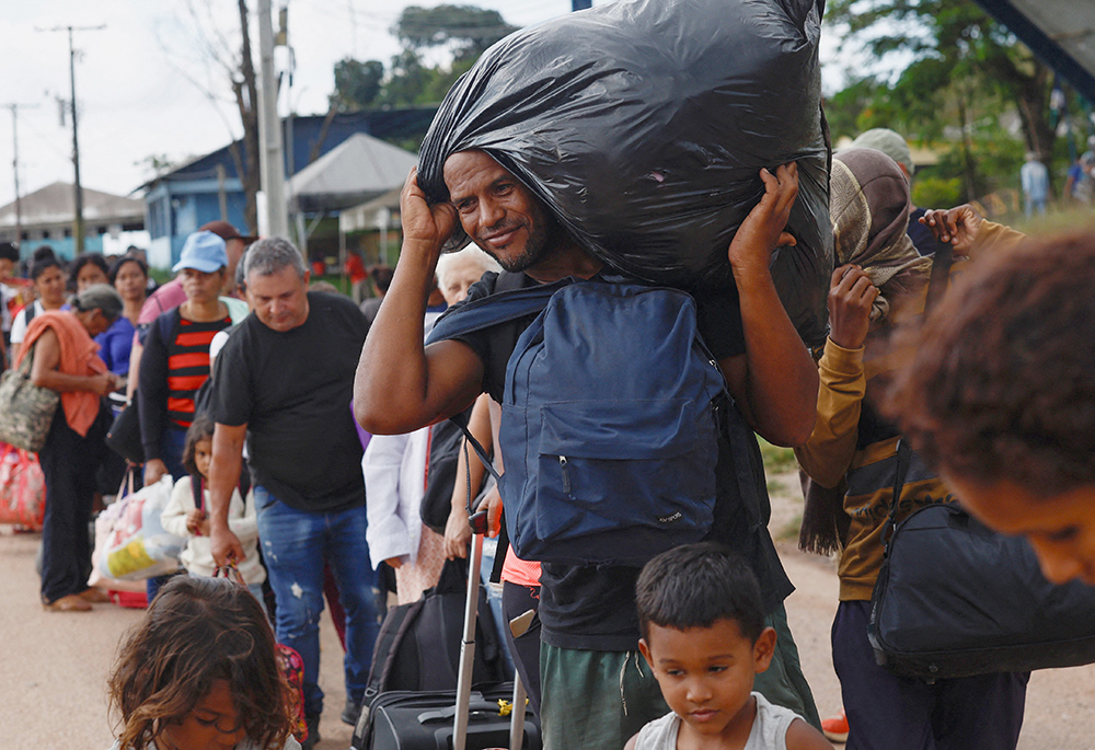 Venezuelans wait to enter a shelter in Pacaraima, Brazil, Sept. 9, after leaving Venezuela, near the border. (OSV News/Reuters/Amanda Perobelli)