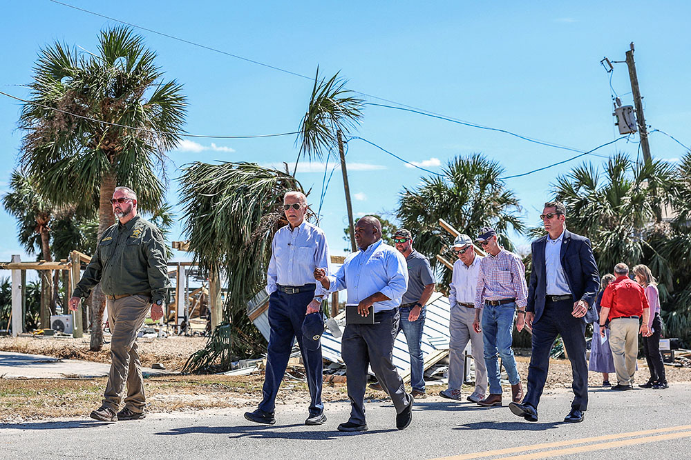 U.S. President Joe Biden speaks with a Federal Emergency Management Agency member Oct. 3, 2024, as he visits storm-damaged areas in Keaton Beach, Fla., in the wake of Hurricane Helene, which made landfall Sept. 26 in the Big Bend region of Florida, near the city of Perry. Helene was followed by Hurricane Milton, one of the strongest hurricanes ever to form in the Gulf of Mexico. Milton made landfall as a major Category 3 hurricane near Siesta Key in Sarasota Oct. 9. (OSV News/Reuters/Tom Brenner)