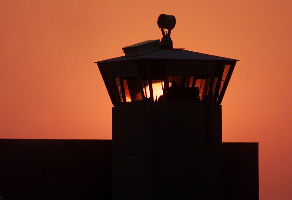 A file photo shows the sun setting behind one of the guard towers at the Federal Correctional Complex in Terre Haute, Indiana. The death chamber at the correctional facility is where the federal death penalty is carried out. (OSV News/Reuters/Andy Clark)