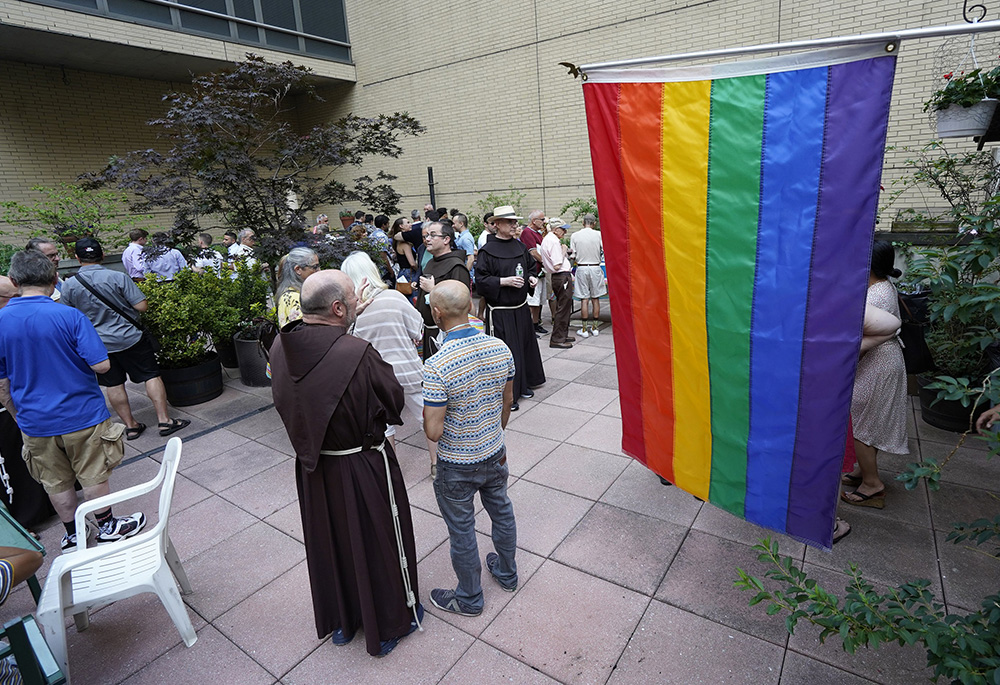 Franciscan friars of St. Francis of Assisi Church in New York City and members of the parish's LGBT+ ministry gather at a reception on June 26, 2021. In 2022, Catholic grandmother Jean joined the Gay and Straight in Christ ministry at St. Mary Parish in Hales Corners, Wisconsin, seeking guidance for supporting her transgender grandson. (CNS/Gregory A. Shemitz)