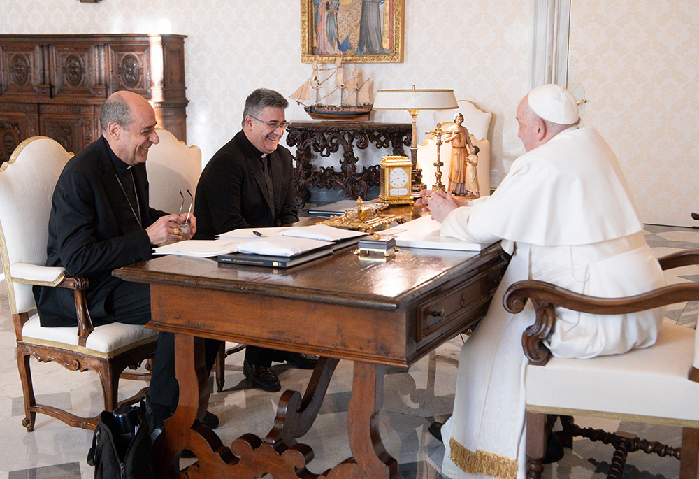 Pope Francis shares a laugh with Cardinal Víctor Manuel Fernández, right, prefect of the Dicastery for the Doctrine of the Faith, and Msgr. Armando Matteo, secretary of the dicastery's doctrinal section, during a meeting in the library of the Apostolic Palace, Dec. 18, 2023, at the Vatican. (CNS/Vatican Media)