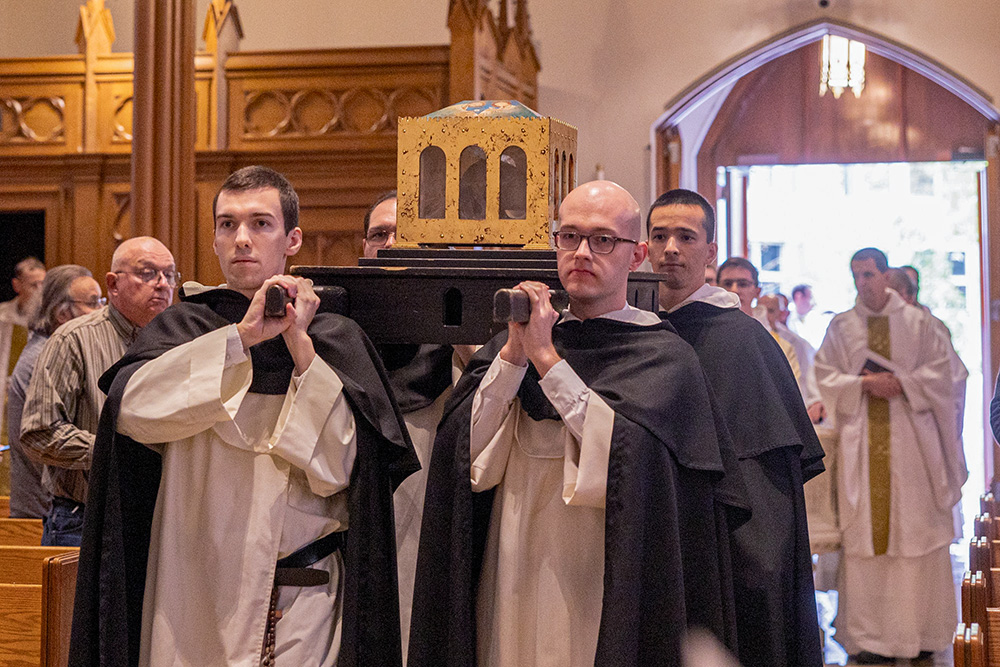 Members of the Dominican order process into St. Dominic Church in Washington carrying a reliquary bearing what is believed to be the skull of St. Thomas Aquinas on Nov. 29, for a Mass celebrated by Cardinal Wilton Gregory. The major relics of the saint were displayed before the altar and then venerated that day. (OSV News/Catholic Standard/Mihoko Owada)