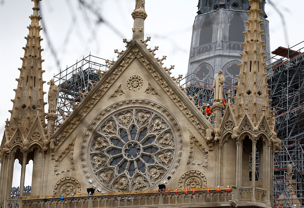 Construction workers are seen on scaffolding at the Notre Dame Cathedral in Paris Dec. 3, which was ravaged by a fire in 2019, as restoration works continue before its planned reopening ceremonies Dec. 7 and 8. (OSV News/Reuters/Stephanie Lecocq)