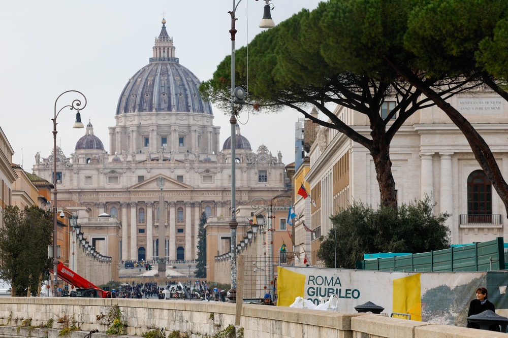 St. Peter's framed by avenue and other buildings, banner foregrounded.