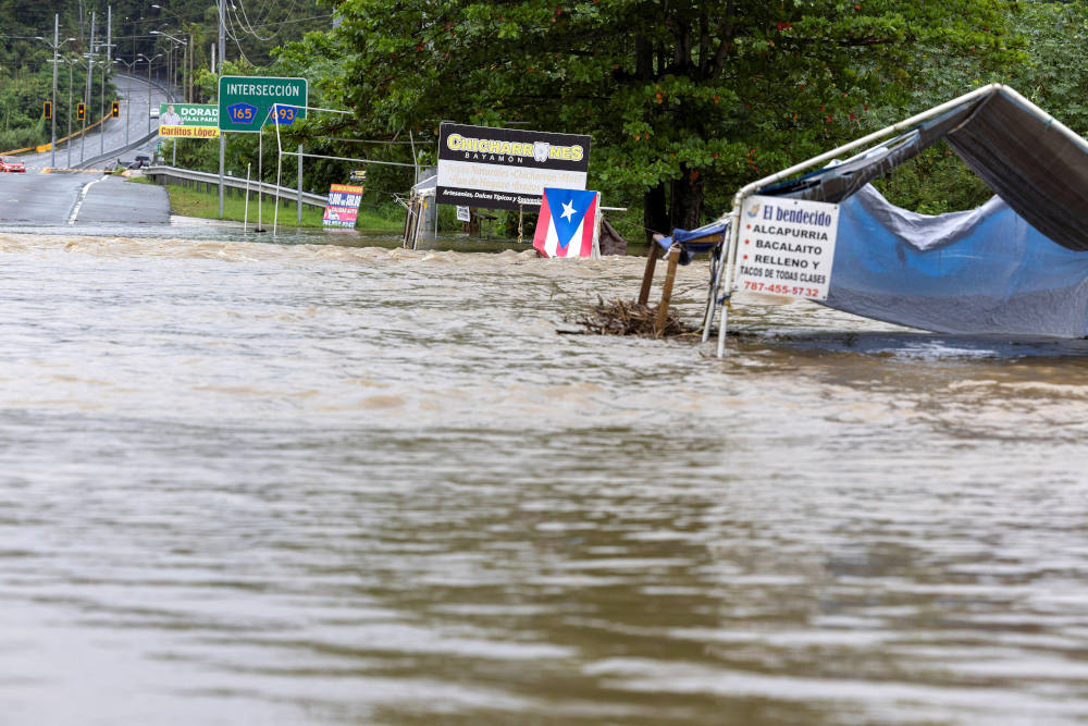 A bridge submerged by the flooded La Plata River in Toa Baja, Puerto Rico, is seen in the aftermath of Hurricane Ernesto Aug.14, 2024. Archbishop Roberto O. Gonzalez Nieves of San Juan suspended Masses and pastoral activities Aug. 13 and 14 as Ernesto battered Puerto Rico, leaving hundreds of thousands without power. (OSV News photo/Ricardo Arduengo, Reuters)